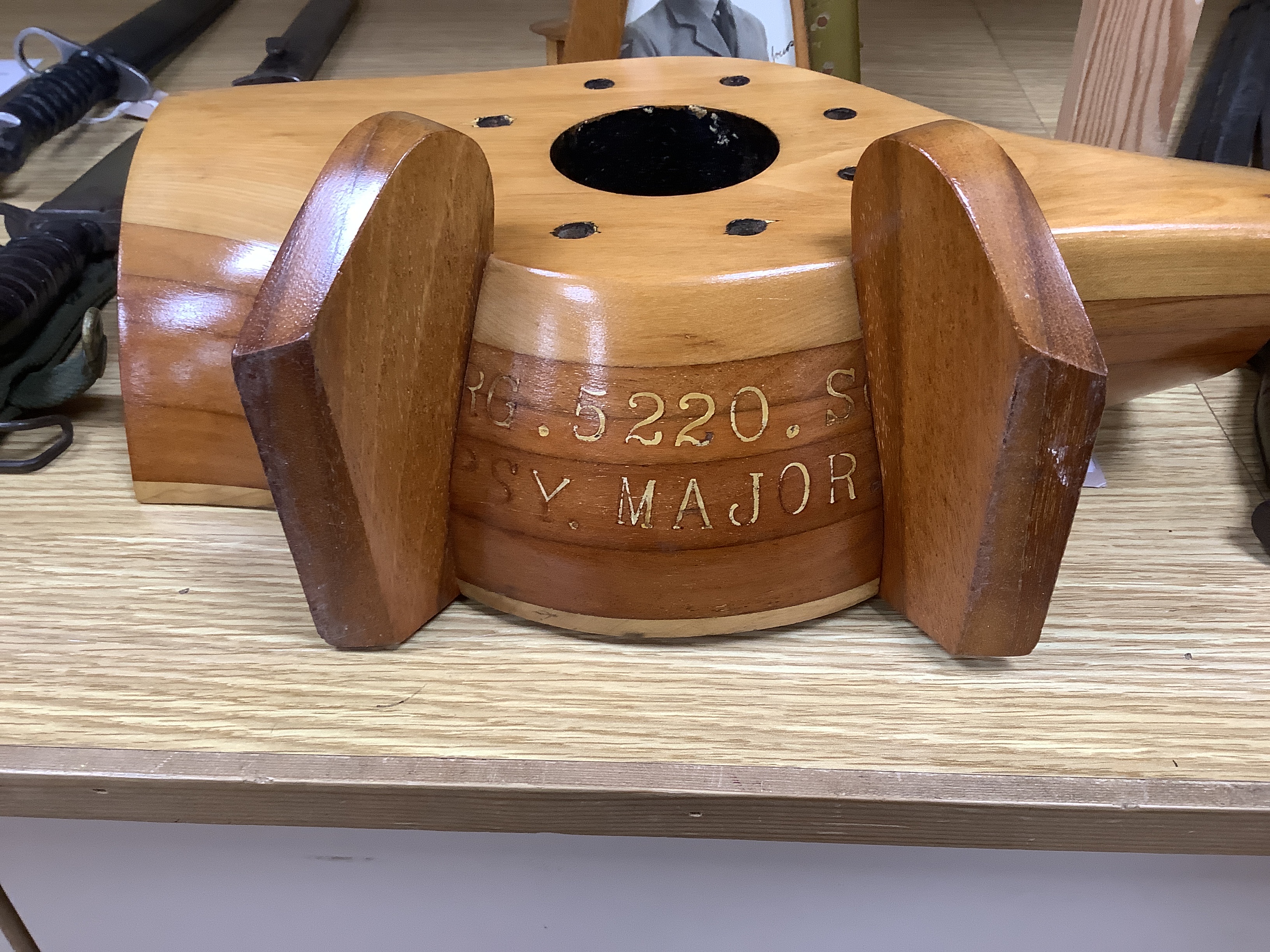 A WWII wooden propeller clock case, reputedly from a Spitfire related photo frame housing a black and white photograph of a soldier together with a trinket box, 35cm wide